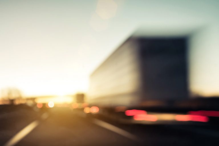 VMF-Vorsitzender Frank Hägele erwartet, dass 2024 ein Übergangsjahr für die Logistikbranche wird. Weil Voraussagen mit einer gewissen Unschärfe verbunden sind, ist auch der im Bild von hinten gezeigte und auf einer Autobahn fahrende LKW unscharf zu sehen.