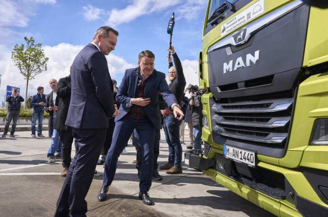 Alexander Vlaskamp (re.), CEO von MAN Truck & Bus, erklärt Bundesverkehrsminister Dr. Volker Wissing die Automatiserungstechnik des MAN Lkw.